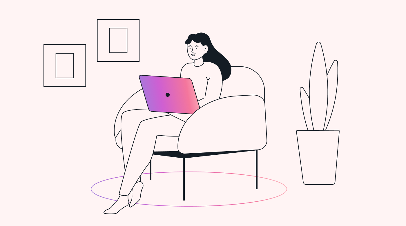A person sat in a chair working on a laptop, next to a plant