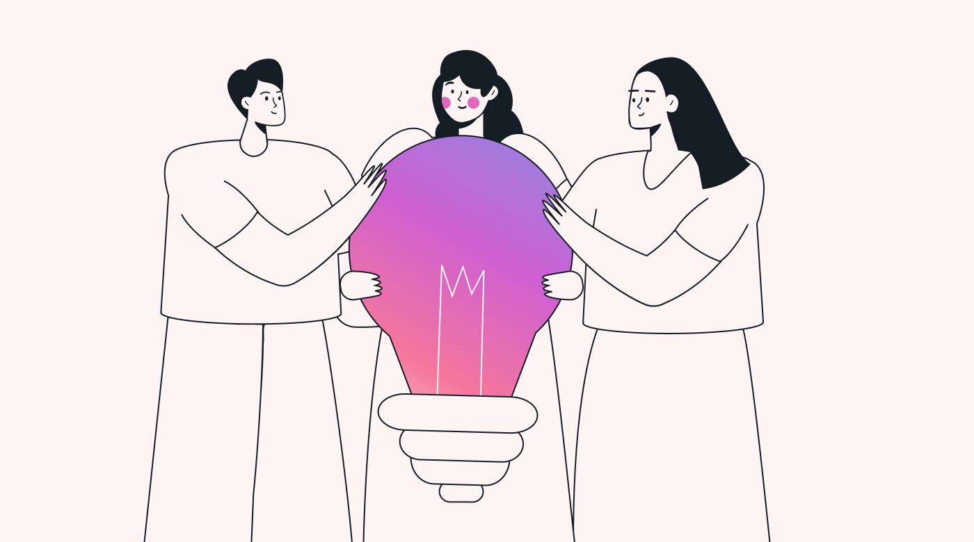 Three people huddled around a large lightbulb